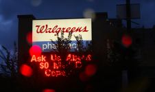 Walgreens pharmacy sign partially hidden by branch
