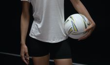 girl in athletic clothes holding volleyball