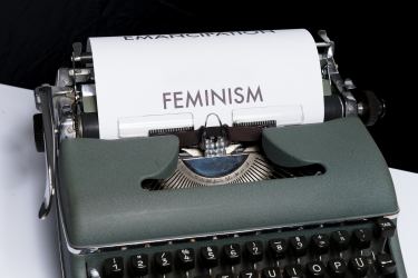 The word "feminism" typed out on a type writer