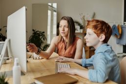 mother and son on a computer