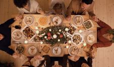 Family seated around a dinner table at christmas