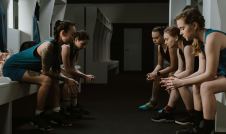 Teen girls sitting in a locker room