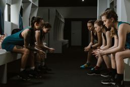Teen girls sitting in a locker room